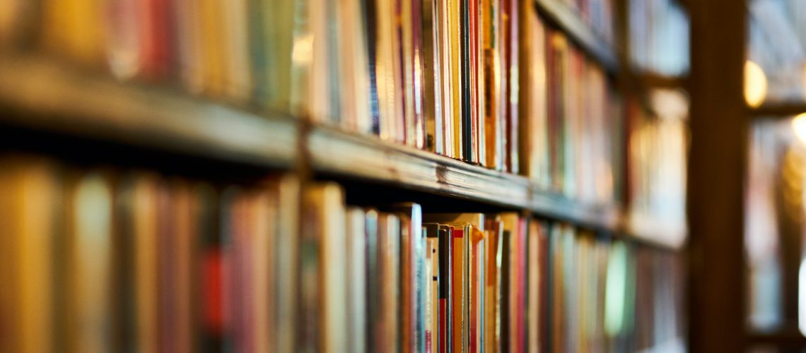 selective-focus-photography-of-brown-wooden-book-shelf-2952871